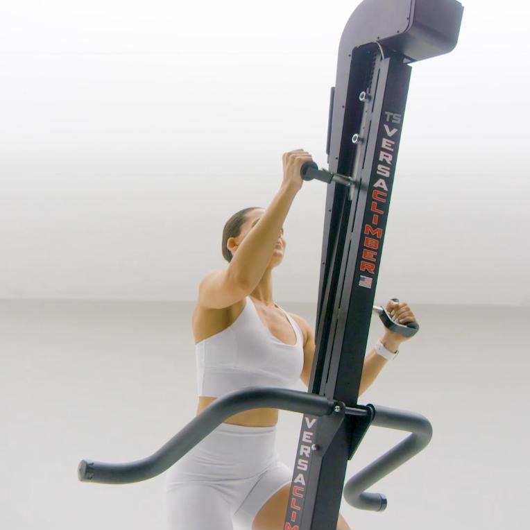 Woman climbing on a VersaClimber TS-M